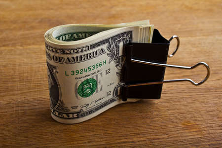pile of money over wood background