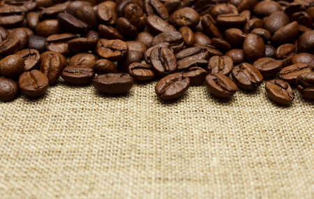 Coffee beans on burlap backgroundの写真素材