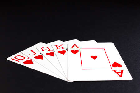 Royal flush of hearts over black backgroundの写真素材