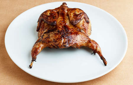 Roasted quail on a white plate close upの写真素材