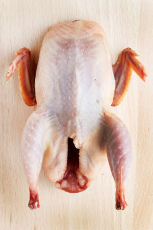 Raw quail on woodの写真素材