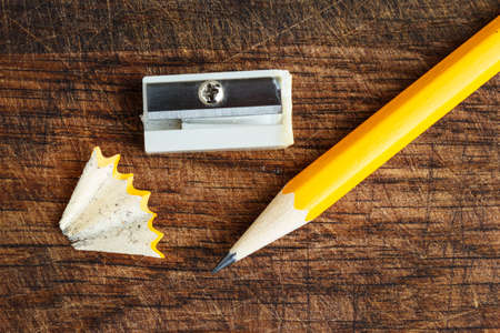 Yellow pencil with sharpener on woodの写真素材