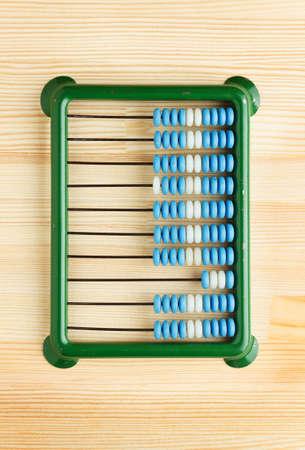 Close-up of abacus on wooden desk