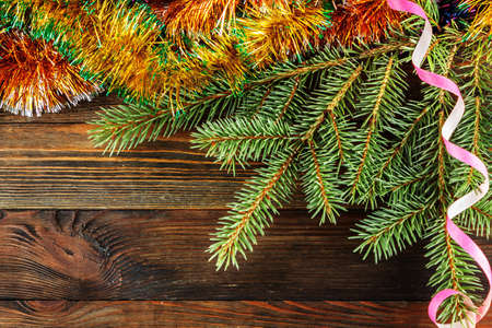 Close-up of fir branch with Christmas decoration on wood backgroundの写真素材