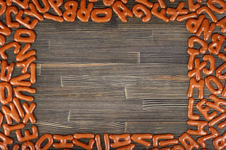 Alphabet biscuits on a wooden board close-upの写真素材
