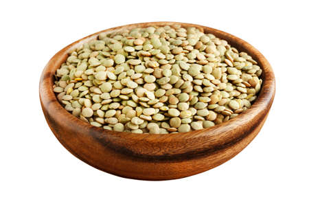 Green lentil in a wooden bowl isolated on whiteの写真素材