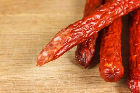 Dried sausages on wood close-upの写真素材