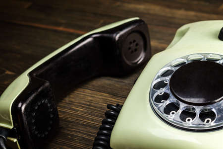 Old telephone on wooden desk close-upの写真素材