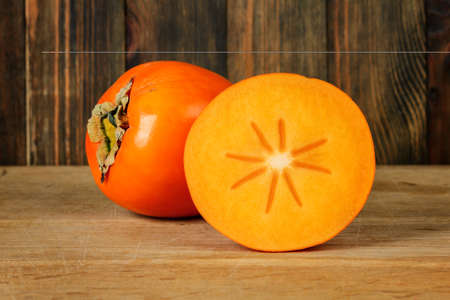 Persimmon on wooden table close-upの写真素材
