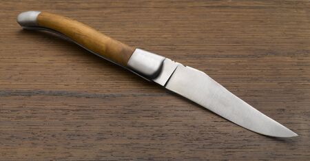 Knife on wooden background