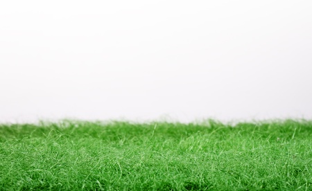 Fake green grass panorama isolated on white background の写真素材