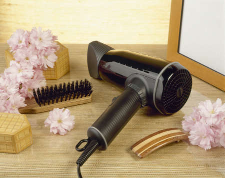 hairdryer and flowers in bathroomの写真素材
