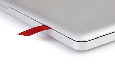 close-up on a red ribbon used as bookmark in a laptopの写真素材