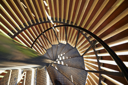 Metal modern spiral staircase details with wooden structureの写真素材
