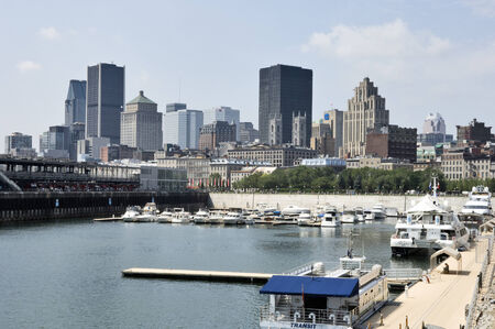 MONTREAL, QUEBEC, AUGUST 10 2010: View of downtown Montreal showing the port on the St. Lawrence River with cruiseship for tourism in Montreal, Quebec, Canada, August 10 2010のeditorial素材
