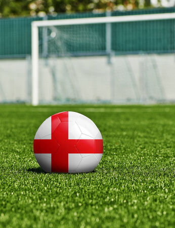 Soccer Ball with England Flag on the grass in stadiumの写真素材