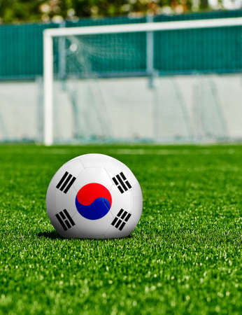 Soccer Ball with Korea republic Flag on the grass in stadiumの写真素材