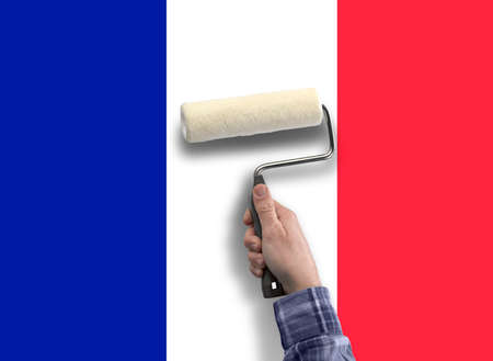 human hand with roller paint the flag from Frenchの写真素材