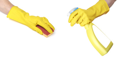 Cleaning surface in bright yellow gloves with sponge and cleaning product on white
