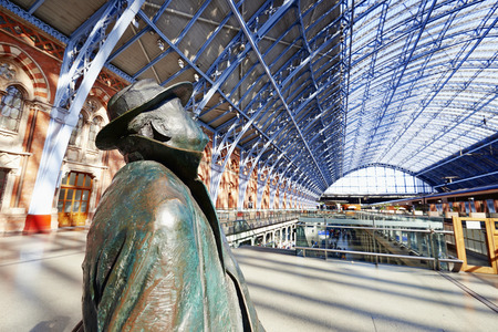LONDON - JUNE 8. Standing in the restored and redeveloped St Pancras International rail station is a statue of Sir John Betjeman who saved the building from demolition; June 8, 2014 in London, UK.のeditorial素材