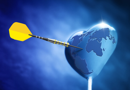 Heart shaped on earth lollipop hit by an arrowの写真素材