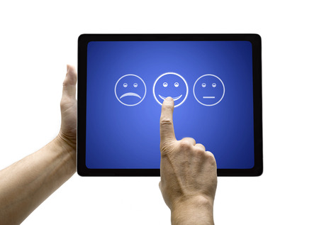 Hand touching screen with customer service evaluation form on a  tablet