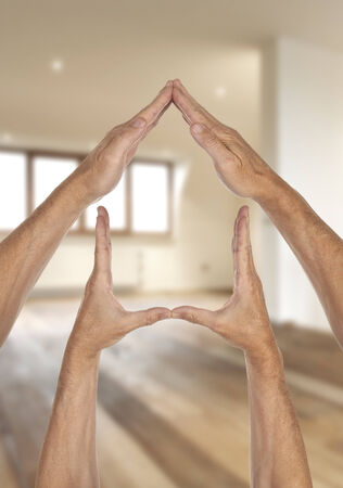 Home symbol insurance family real estate concept- Hands against apartment viewの写真素材