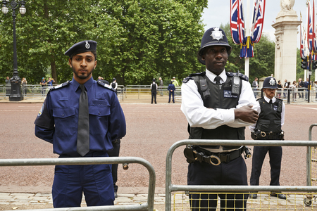 LONDON, ENGLAND - June 07, 2014: Heavily armed police officers on Guard near Buckingham Palace,...
