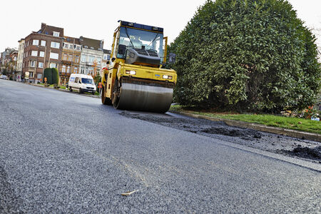 BRUSSELS, BELGIUM - NOVEMBER 29, 2014:  Heavy Vibration roller compactor at asphalt pavement works for road repairing on November 29, 2014 in Brussels, Belgiumのeditorial素材