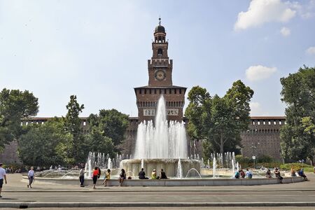 MILAN, ITALY- JUNE 11, 2015: People appreciate the fountain in front of  the Castello Sforzesco which is the oldest and largest castle in town and a major tourists destinationのeditorial素材