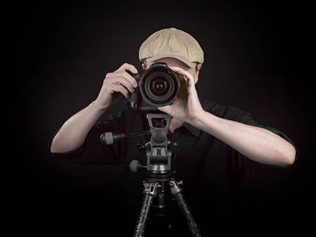 A photographer with a nice camera on black background
