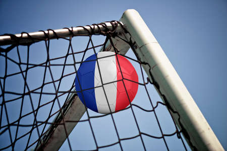 Soccerball in net with the flag of France ready for championshipの写真素材
