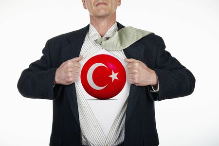 Superhero pulling Open White Shirt with soccer ball flagged Turkey on white backgroundの写真素材