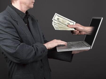 Man in black shirt and suit holding a laptop and win a lot of money