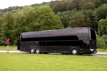 Black Travel  bus standing in a country roadの写真素材