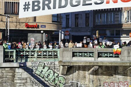 BRUSSELS, BELGIUM - January 20, 2017: Greenpeace organise demonstration for Bridges Not Walls: anti-Trump protesters have dropped banners on the bridge between Molenbeek and Brussels centerのeditorial素材