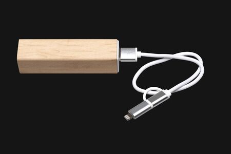 Wooden portable external power bank, for emergency phone recharge isolated on Black with clipping pathの写真素材