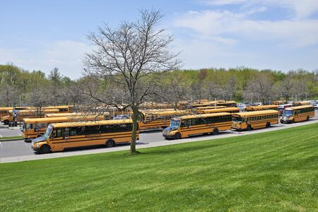 MONTREAL, QUEBEC, CANADA - 18 MAY 2017: Lot of school buses waiting for children in a parking at the Mont Royal in Montrealのeditorial素材