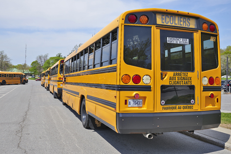 MONTREAL, QUEBEC, CANADA - 18 MAY 2017: Lot of school buses waiting for children in a parking at the Mont Royal in Montrealのeditorial素材