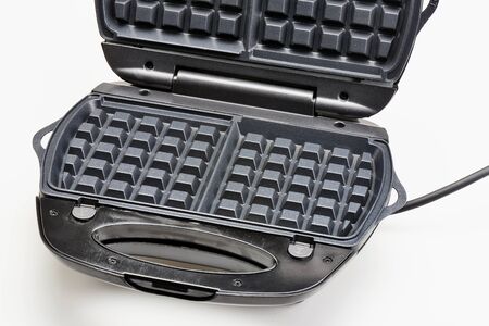 Open waffle iron maker isolated on a white background 
