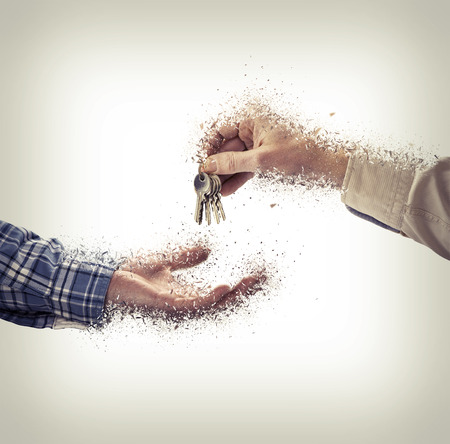 Man is handing a house key to a other man in shattered styleの写真素材