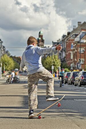 BRUSSELS, BELGIUM - SEPTEMBER 17, 2017: Young teenager boy practice skateboarding during the Car Free Streets day on Demolder Ave. in Brussels, Belgiumのeditorial素材
