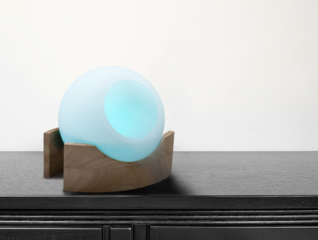 colored air freshener in glass container on black deskの写真素材