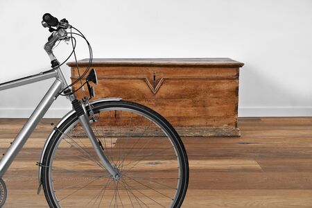 Modern interior with vintage wooden chest and bike in foregroundの写真素材