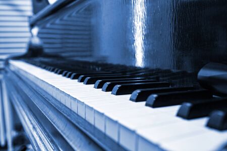 Cyanotype version of a Old and vintage piano keyboard in perspective close upの写真素材