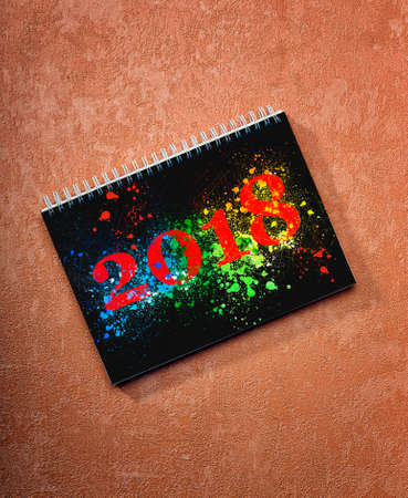 Happy new year 2018 desk calendar on on painted background, Path for the first sheet.の写真素材