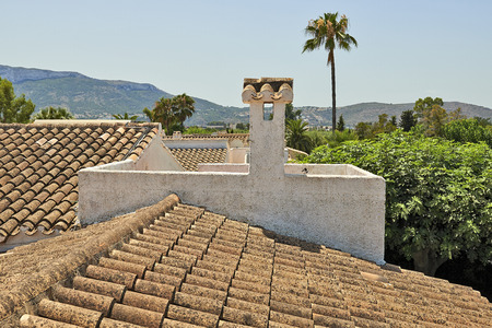 Detail and perspective of a grungy old tiles roof in south Europeの写真素材
