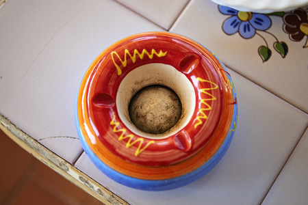 Colored empty ashtray on ceramic tableの写真素材