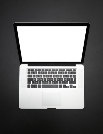 Modern laptop device from above on black table. Clipping path for laptop and screenの写真素材