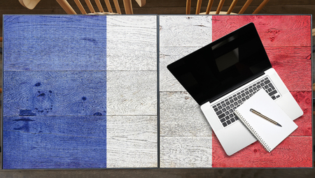 France flagged wooden Table with laptop in restaurantの写真素材